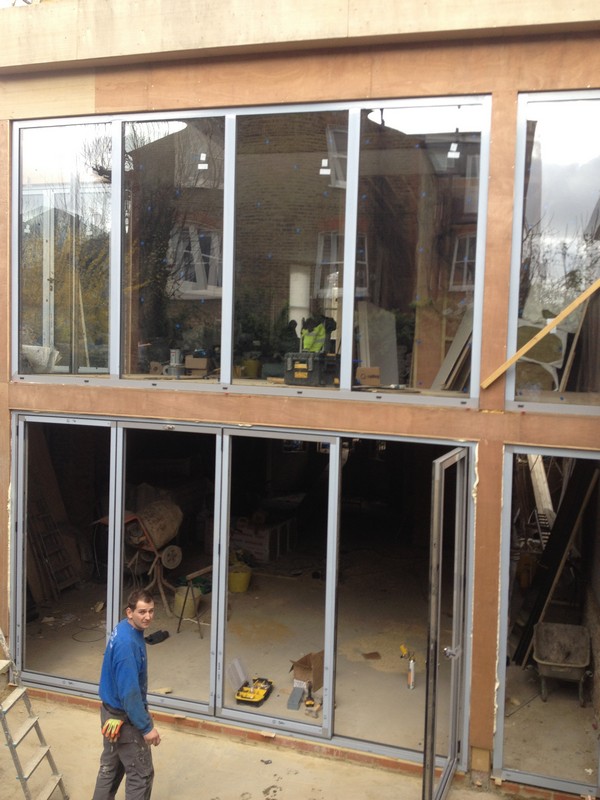 Aluminium bi-fold doors with two-storey glazing in Sutton