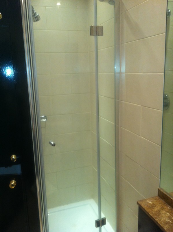 Frameless glass shower enclosure with chrome fittings in Sutton
