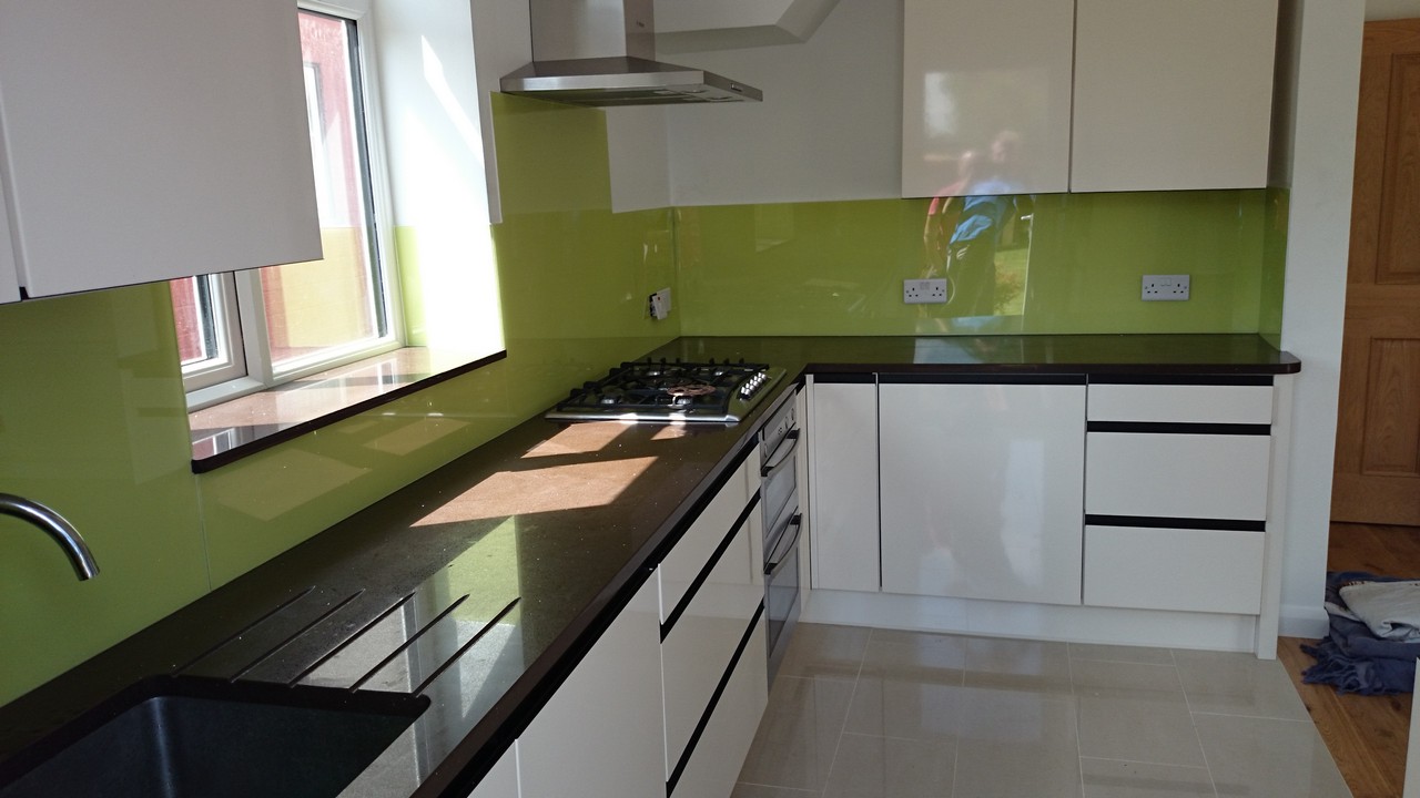 Lime green glass kitchen splashback installed by Sutton glaziers