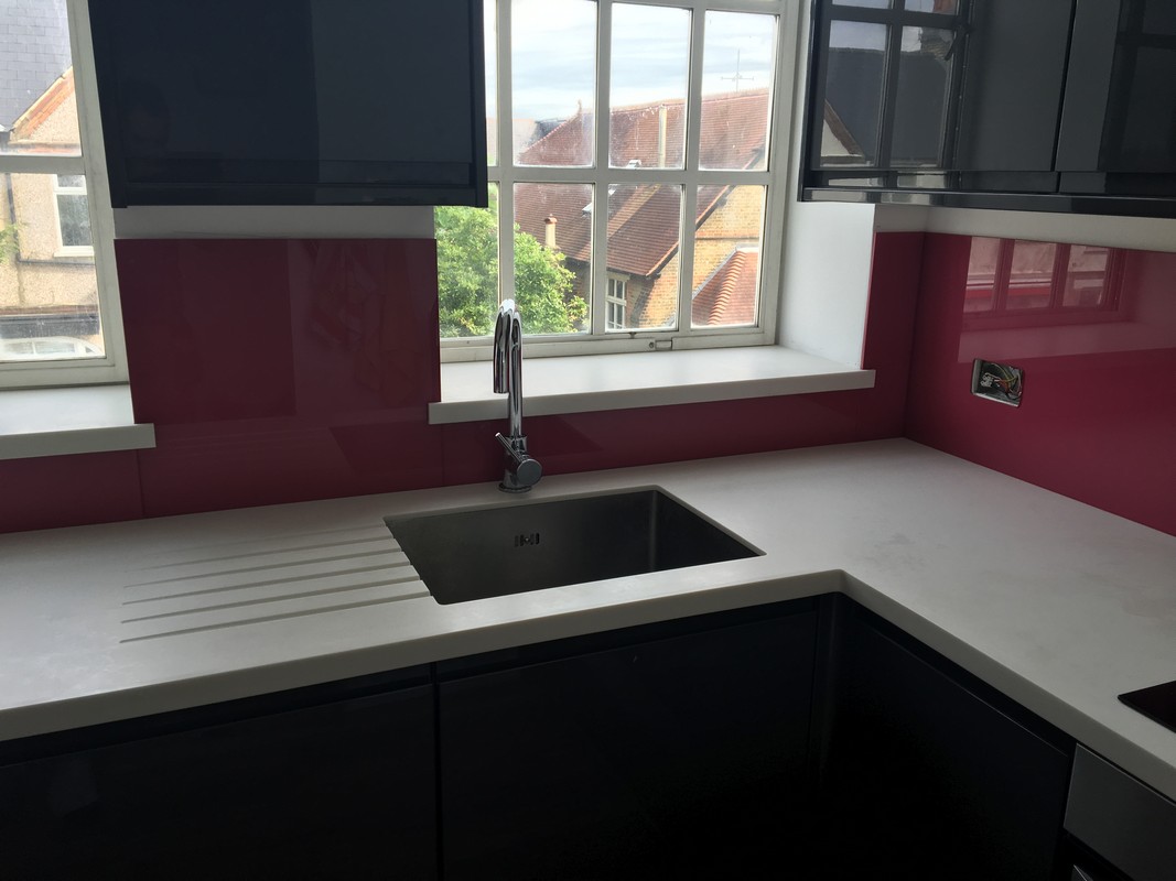 Deep plum coloured glass splashback in modern Sutton kitchen