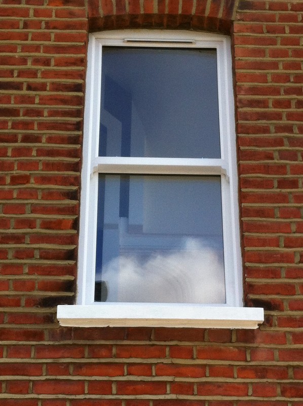 uPVC sash window on Victorian red brick house in Sutton